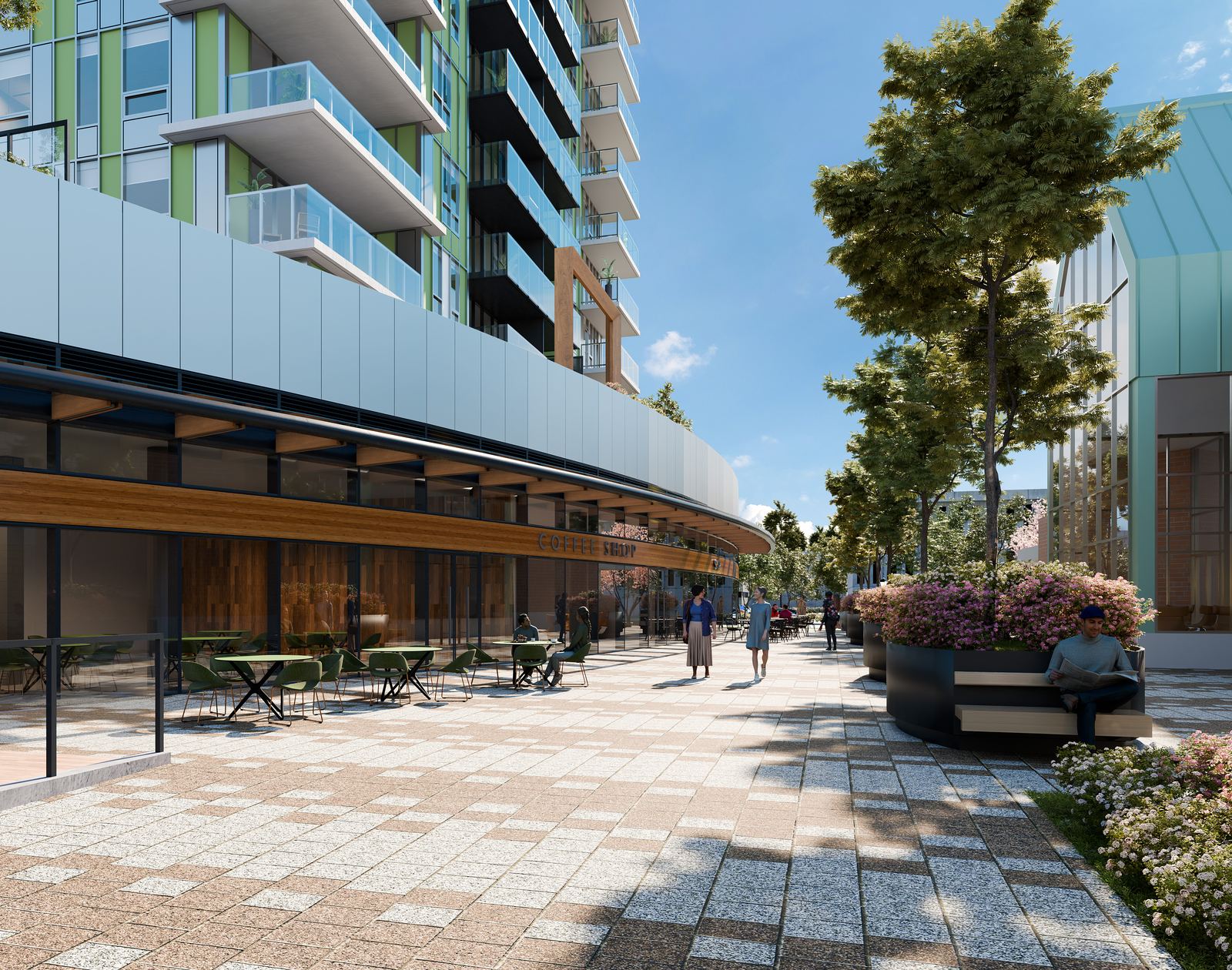 Street-level plaza beside the building, with a paved walkway, cafe seating, planters in bloom and people walking in the sunshine.